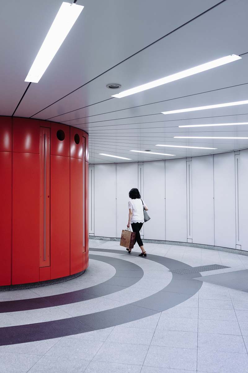 tochomae station woman walking in hallway shinjuku
